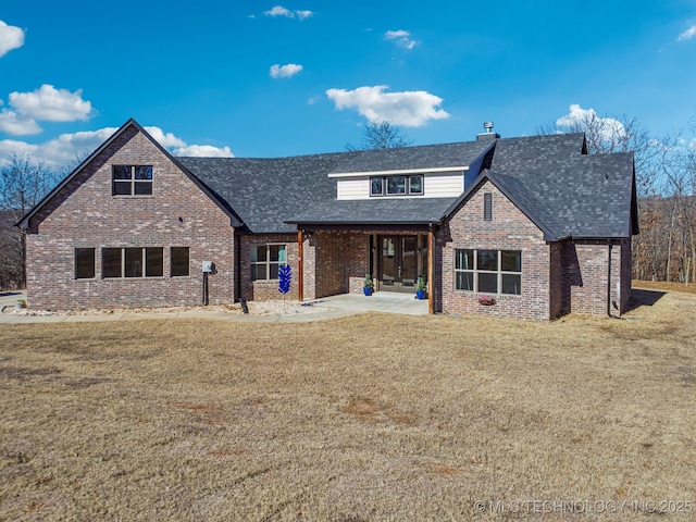 view of front of home featuring a front lawn and french doors