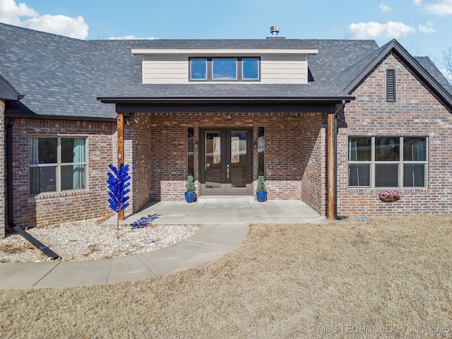 view of front of house with a front yard and french doors