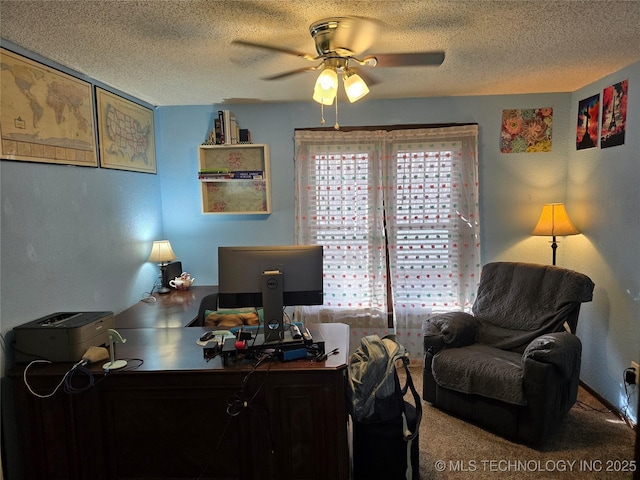 carpeted office featuring ceiling fan and a textured ceiling