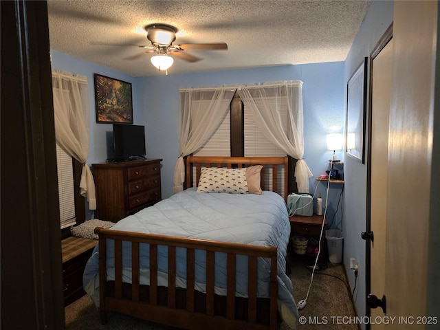 bedroom featuring carpet, a textured ceiling, and ceiling fan