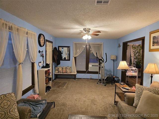 workout area with cooling unit, ceiling fan, carpet floors, and a textured ceiling