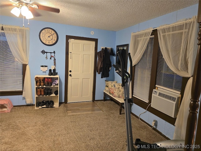 carpeted foyer entrance with cooling unit, ceiling fan, and a textured ceiling