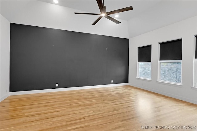 unfurnished room featuring lofted ceiling, ceiling fan, and light hardwood / wood-style flooring