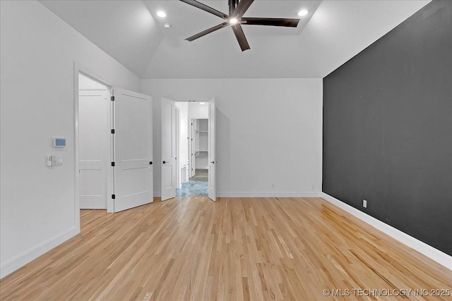 unfurnished bedroom featuring ceiling fan, lofted ceiling, and light hardwood / wood-style floors