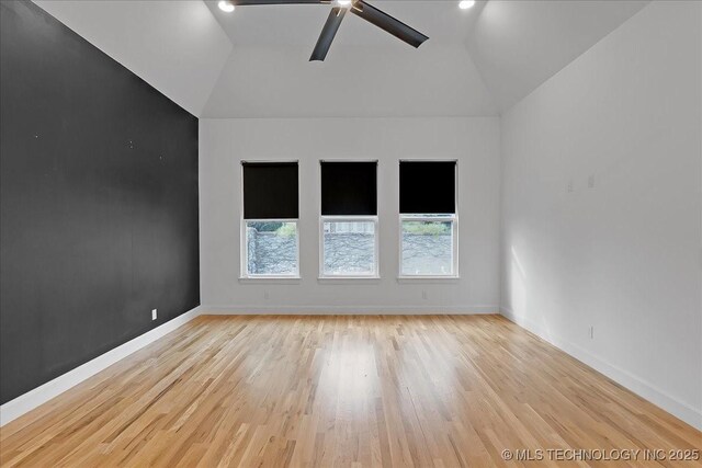 unfurnished room featuring vaulted ceiling, ceiling fan, and light hardwood / wood-style floors