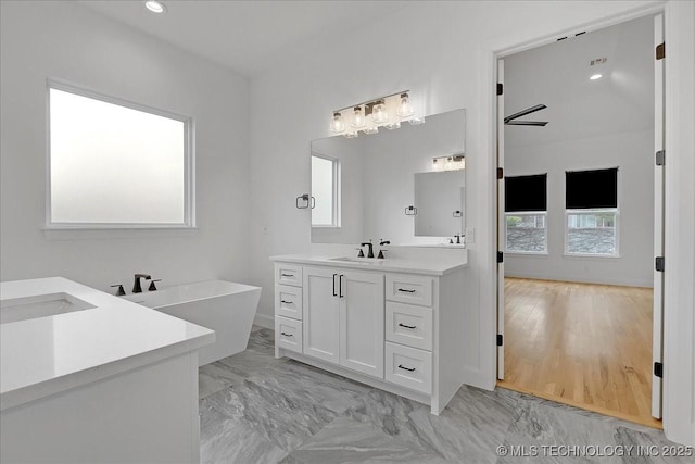 bathroom with vanity and a bathtub