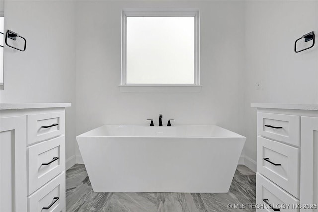 bathroom featuring vanity and a bathing tub