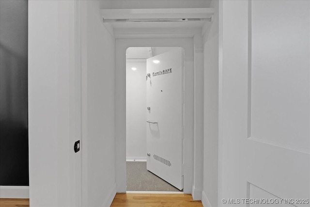 corridor featuring hardwood / wood-style flooring