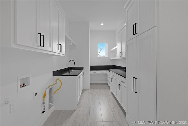 kitchen featuring sink, white cabinets, and black electric cooktop