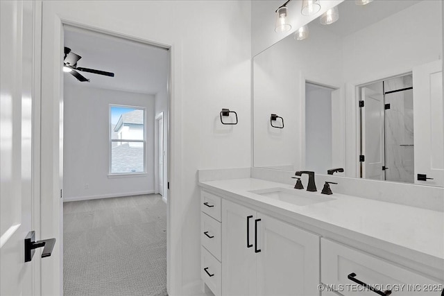 bathroom with ceiling fan, vanity, and a shower