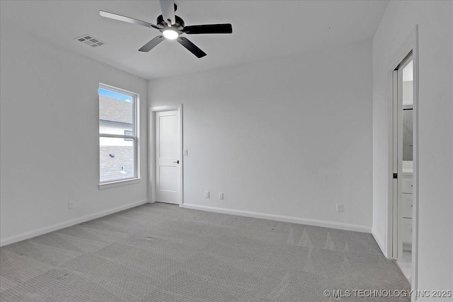 empty room featuring light carpet and ceiling fan