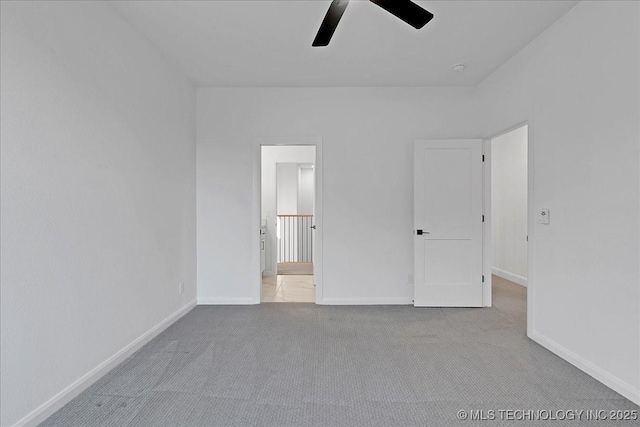 unfurnished bedroom featuring light colored carpet and ceiling fan