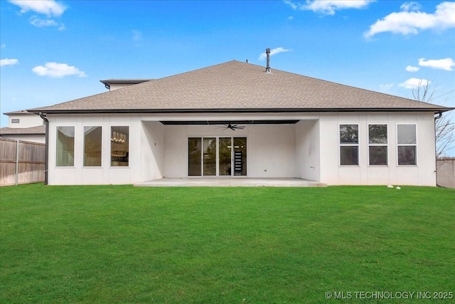 rear view of house featuring a yard, ceiling fan, and a patio area