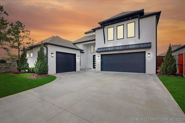 modern home with a garage and a lawn