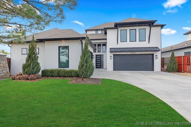 view of front of home featuring a garage and a front lawn