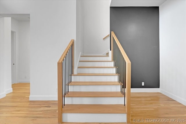 staircase with wood-type flooring