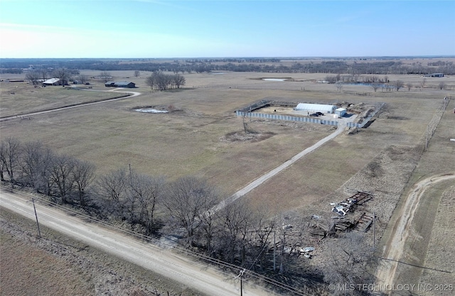 birds eye view of property with a rural view