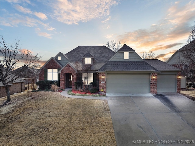 view of front of property with driveway, brick siding, an attached garage, and a shingled roof