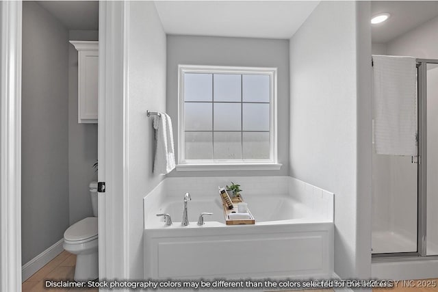 bathroom featuring shower with separate bathtub and toilet