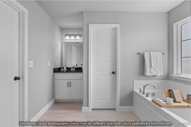 bathroom featuring vanity and a washtub