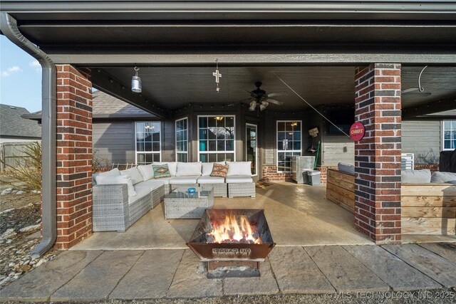 view of patio / terrace featuring an outdoor living space with a fire pit and ceiling fan