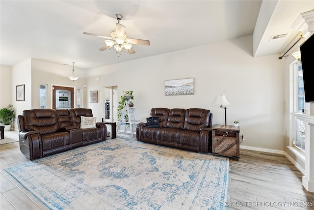 living room featuring ceiling fan and light wood-type flooring