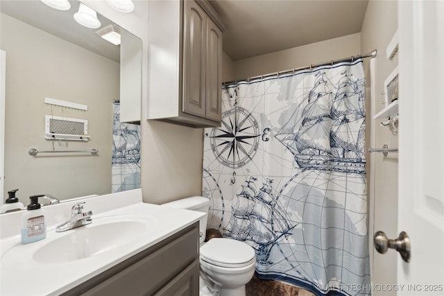 bathroom featuring walk in shower, vanity, and toilet