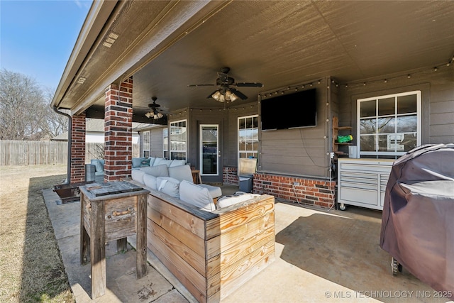 view of patio with an outdoor living space and ceiling fan