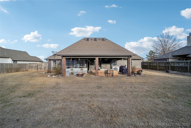 rear view of house with a lawn and a patio area