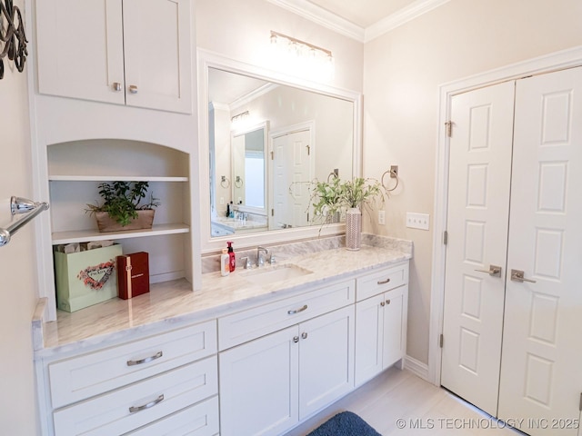 bathroom with vanity and ornamental molding