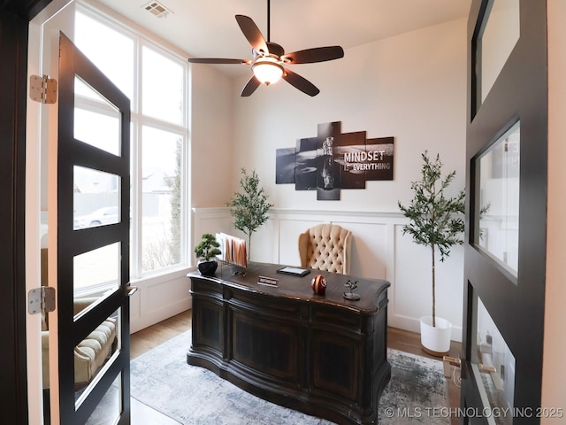 office space featuring ceiling fan and light wood-type flooring