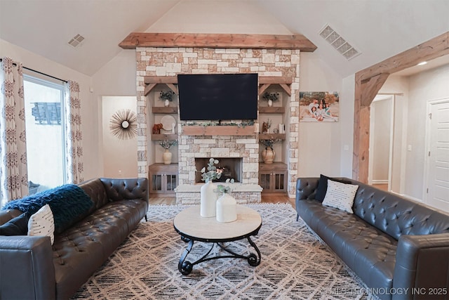 living room with hardwood / wood-style floors, a stone fireplace, and vaulted ceiling