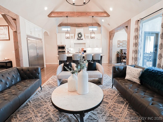 living room with high vaulted ceiling, sink, hardwood / wood-style floors, and beam ceiling