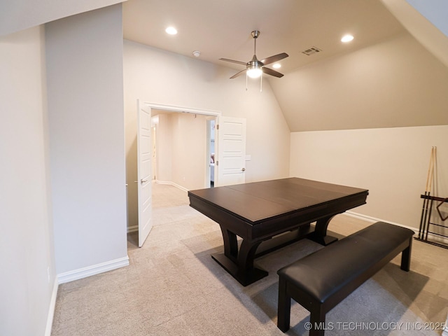 dining room featuring ceiling fan, light colored carpet, and vaulted ceiling