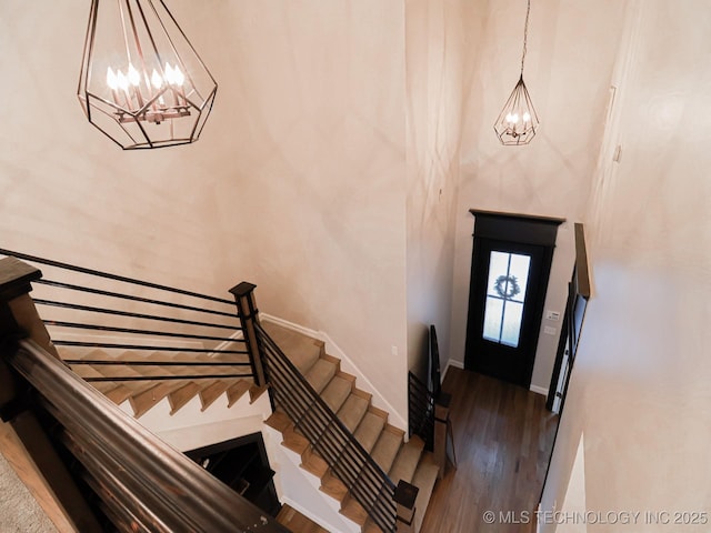 foyer featuring an inviting chandelier and dark hardwood / wood-style flooring