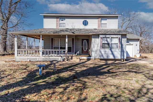 farmhouse with a garage, covered porch, and a front yard