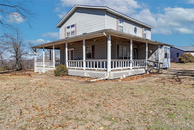 farmhouse with a porch and a front lawn