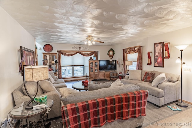 living room featuring light hardwood / wood-style floors and ceiling fan