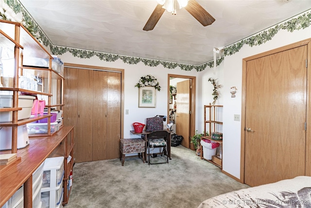 carpeted bedroom with ceiling fan and a closet