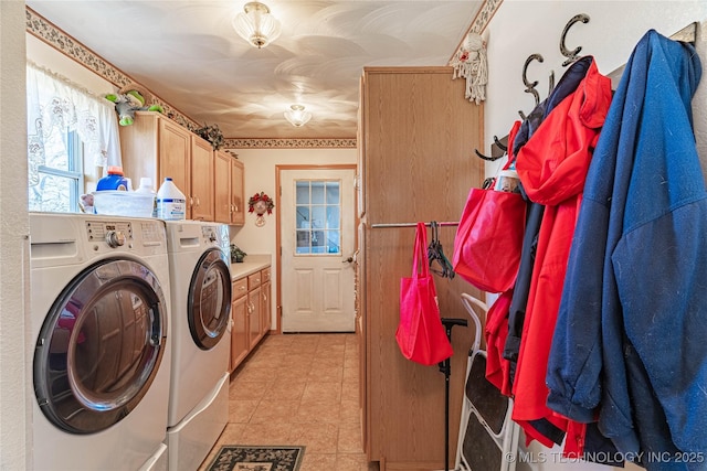 laundry area with cabinets and washing machine and clothes dryer