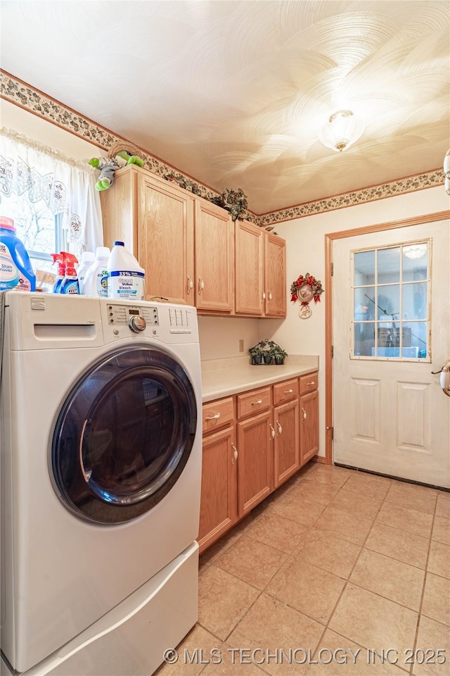 laundry room featuring washer / clothes dryer, light tile patterned floors, and cabinets