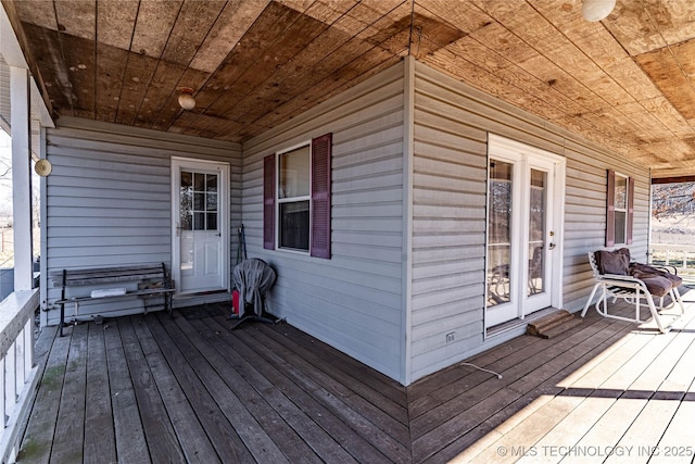 wooden terrace featuring covered porch