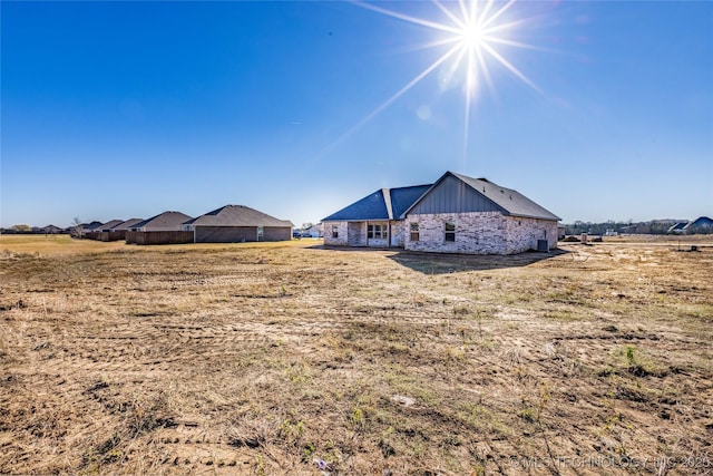 rear view of house featuring a rural view