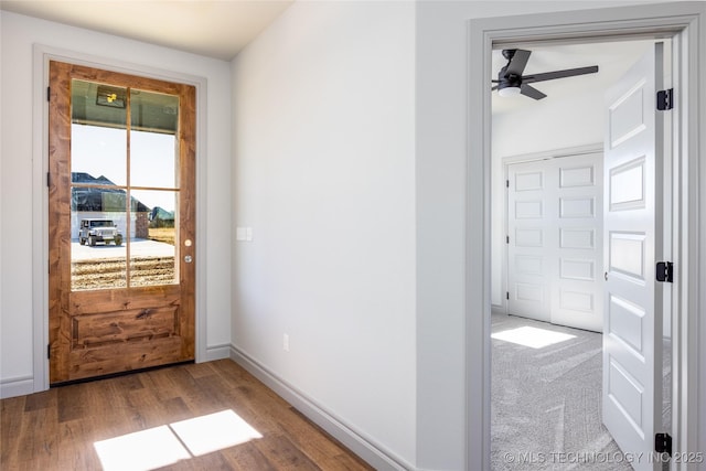 doorway to outside featuring ceiling fan and light hardwood / wood-style flooring