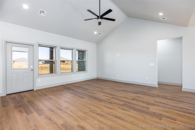 unfurnished living room featuring hardwood / wood-style flooring, ceiling fan, and high vaulted ceiling