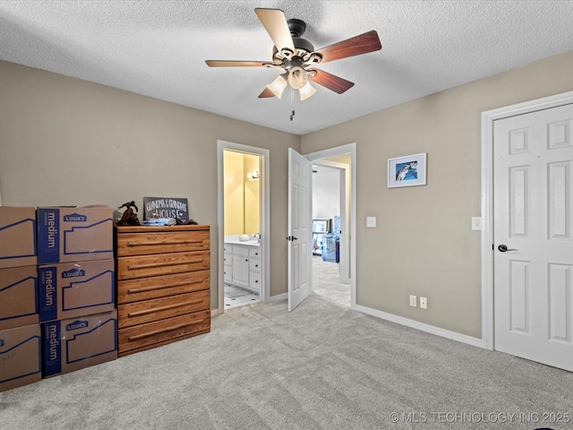 carpeted bedroom featuring ceiling fan, connected bathroom, and a textured ceiling