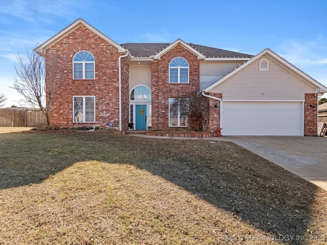 front facade featuring a garage and a front lawn