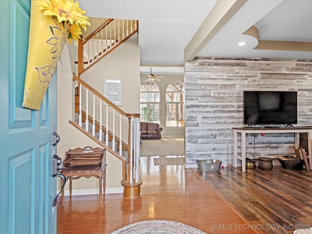 foyer entrance featuring wood-type flooring and ceiling fan