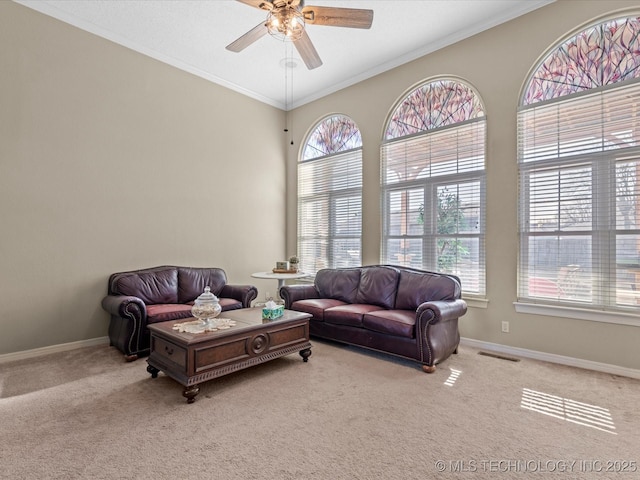 living room featuring crown molding, light colored carpet, and ceiling fan