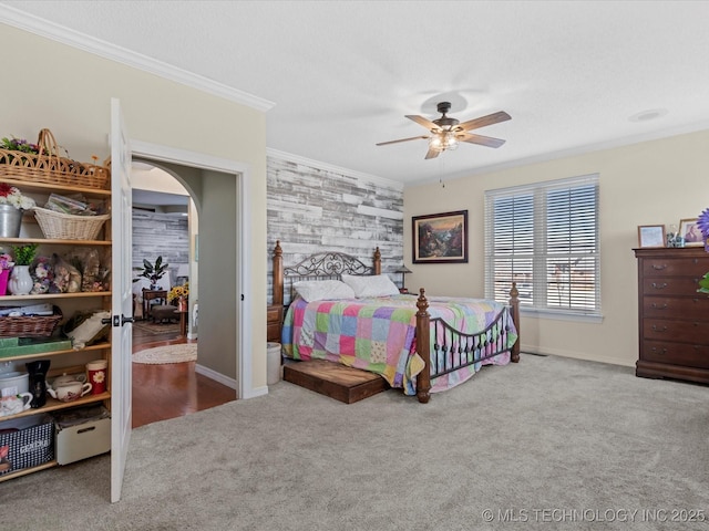 carpeted bedroom with crown molding and ceiling fan